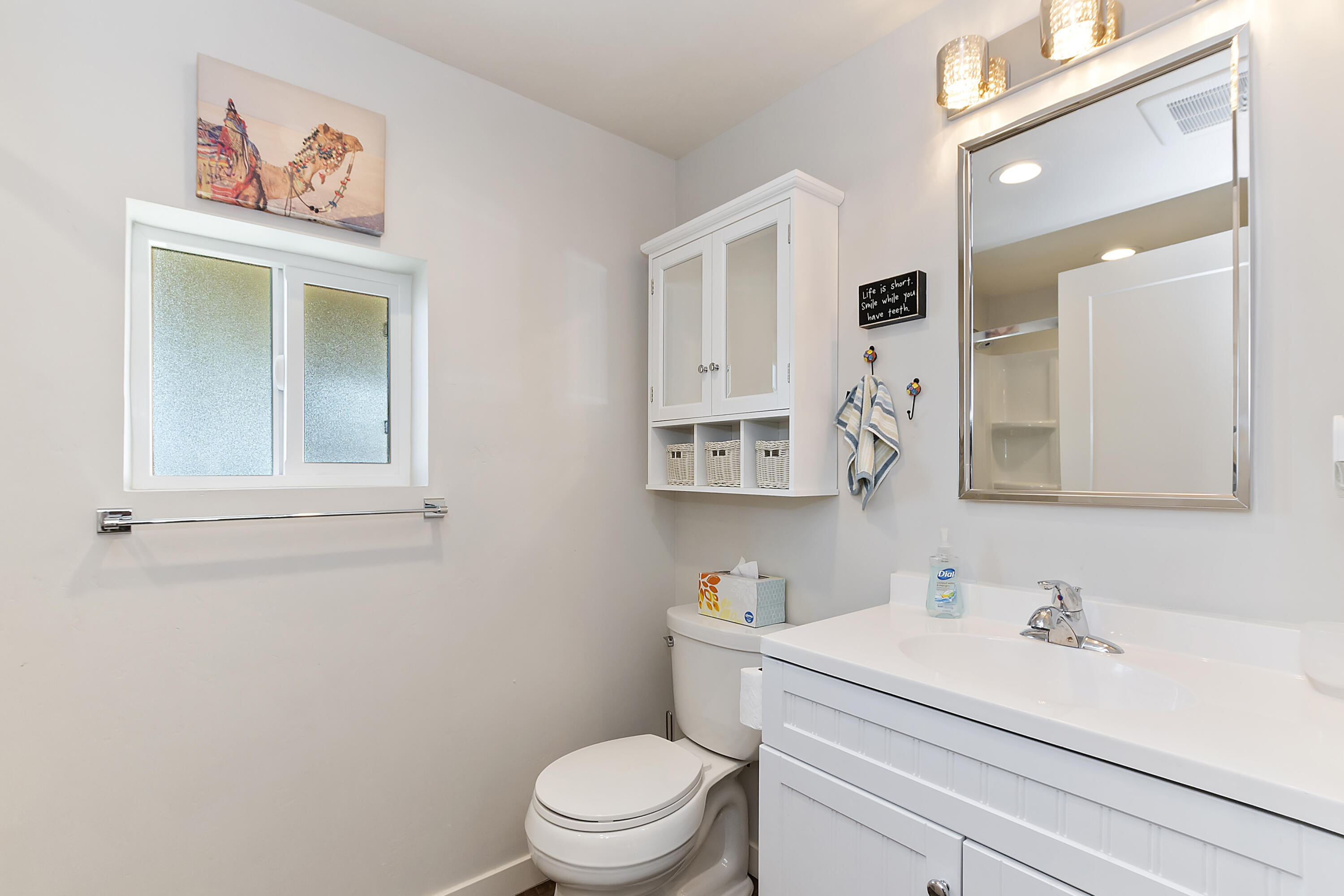 70260 Highway 111, Unit 60 Rancho Mirage, CA 92270 - Photo 13 of 15 a bathroom with a sink a toilet and mirror