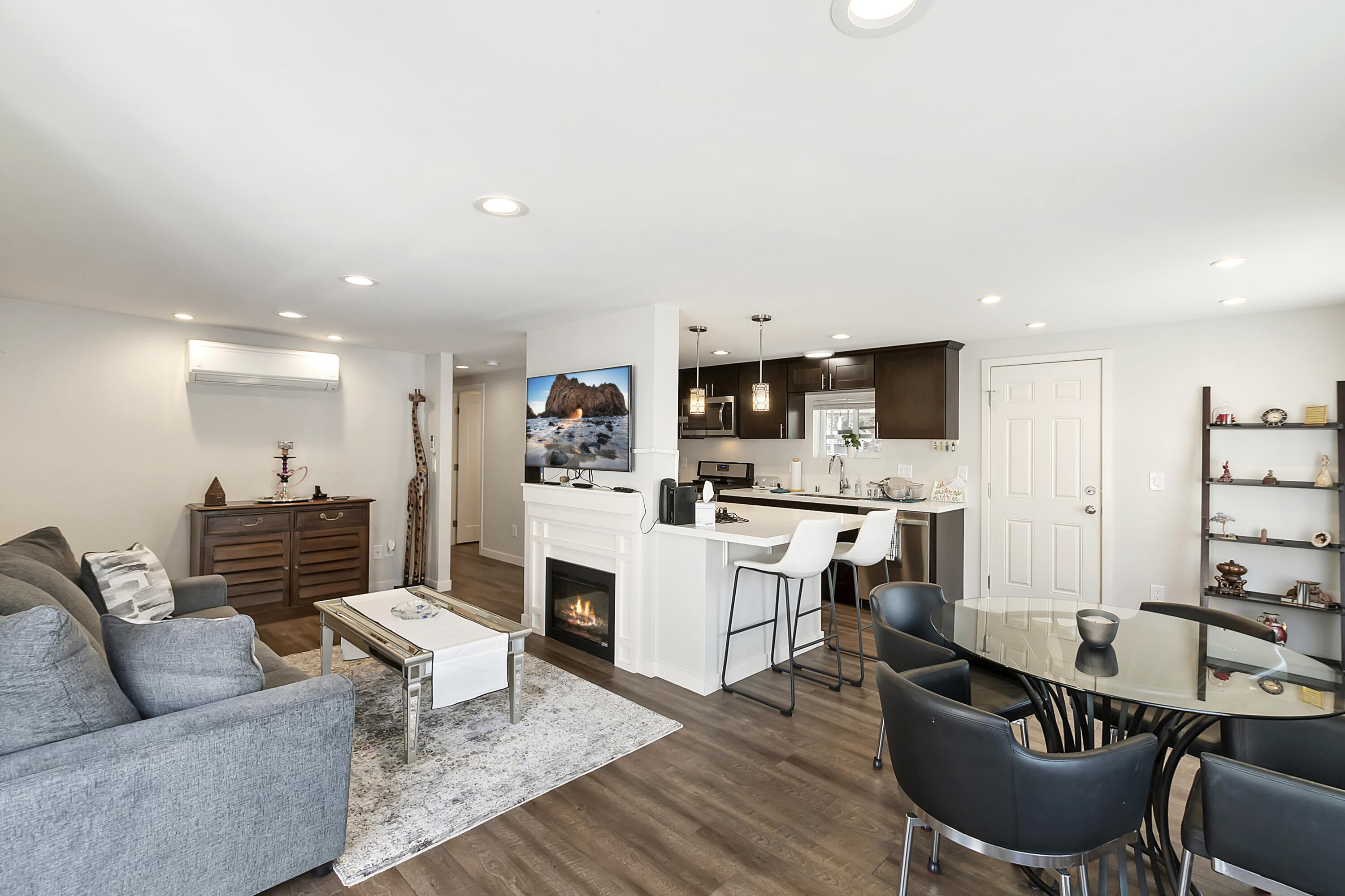 70260 Highway 111, Unit 60 Rancho Mirage, CA 92270 - Photo 6 of 15 a living room with furniture a kitchen view and a fireplace