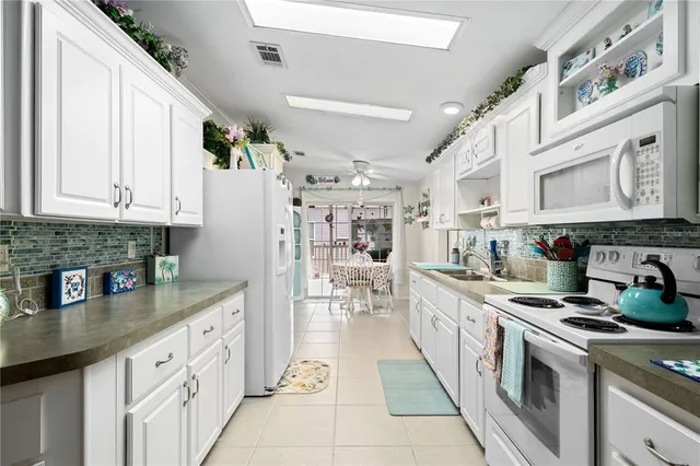 a kitchen with stainless steel appliances granite countertop a sink and cabinets