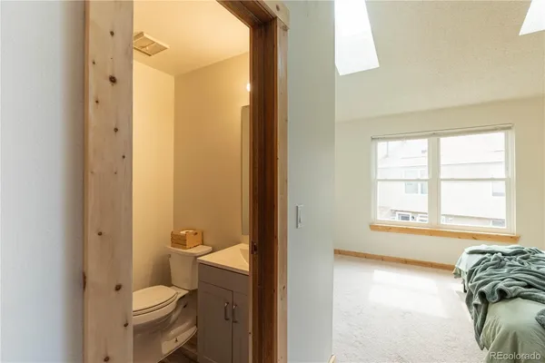 a bathroom with a toilet and a shower curtain