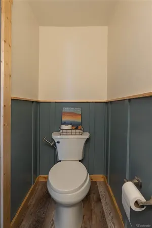 a bathroom with a toilet and a mirror