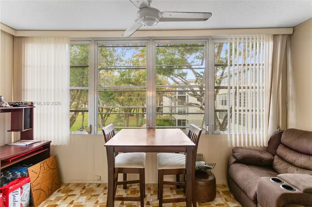 a view of a dining room with furniture window and outside view