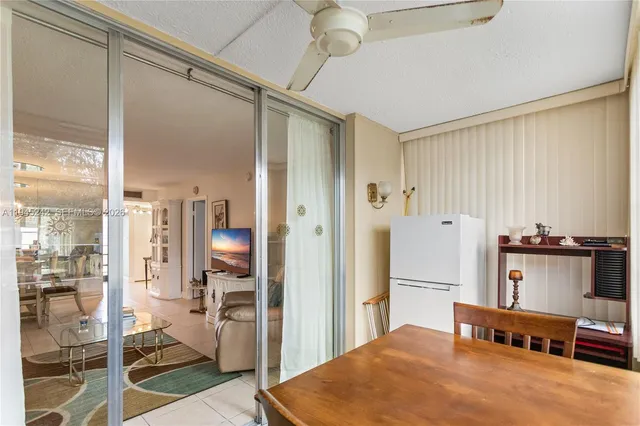 a open kitchen with stainless steel appliances granite countertop a refrigerator and a stove top oven