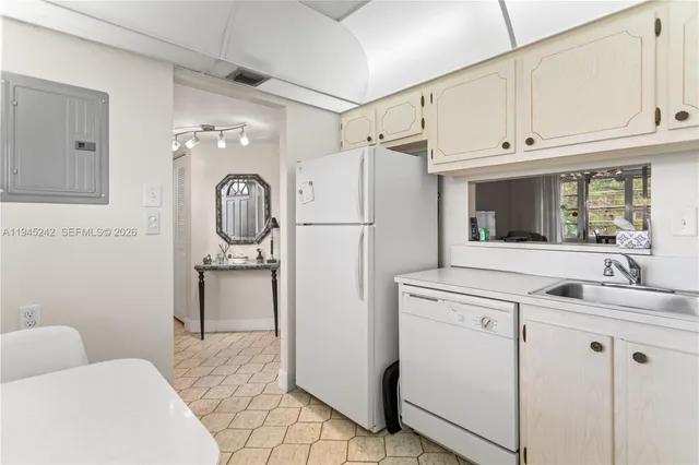 a kitchen with a refrigerator a washer and dryer