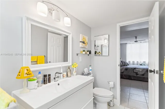 a bathroom with a sink toilet vanity and mirror