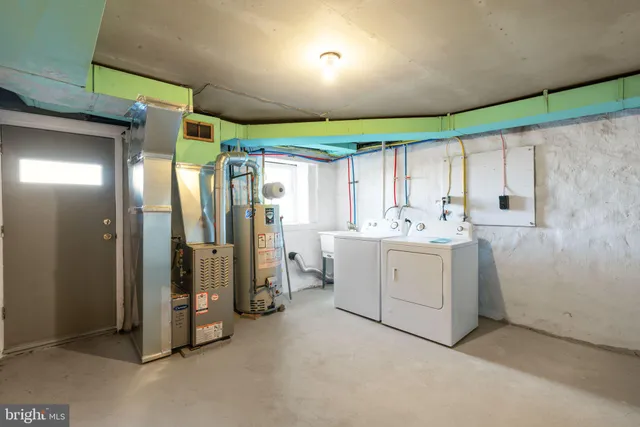 a utility room with cabinets dryer and washer
