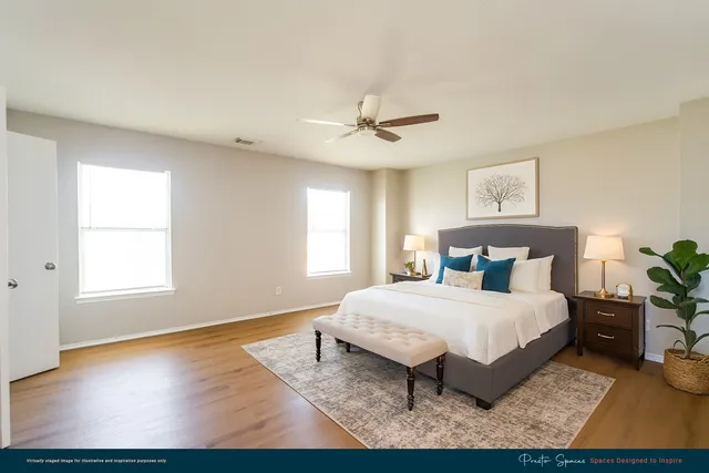 a bedroom with a bed chandelier and a window