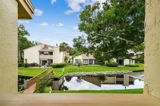 a kitchen with stainless steel appliances a sink a stove top oven a counter space cabinets and wooden floor