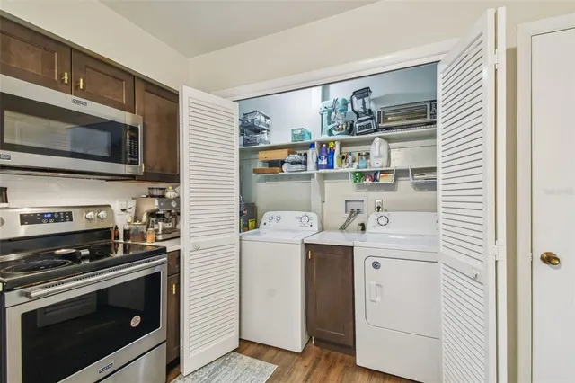 a kitchen with stainless steel appliances a stove sink and microwave
