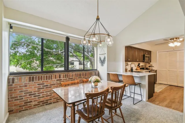 a kitchen with kitchen island granite countertop a sink cabinets and stainless steel appliances