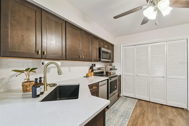 a small pool with a bench and trees in the background