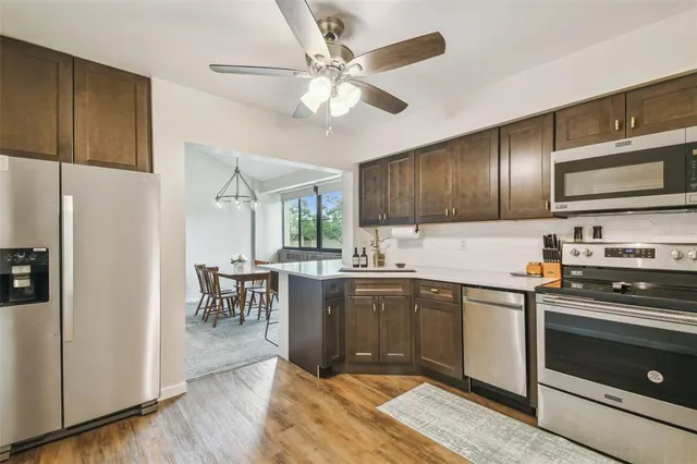 a view of a roof deck with couches and a yard