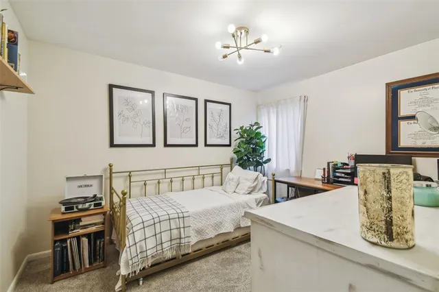 a bedroom with a bed and a large dresser