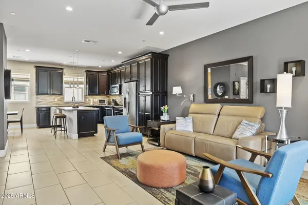 a living room with furniture and kitchen view