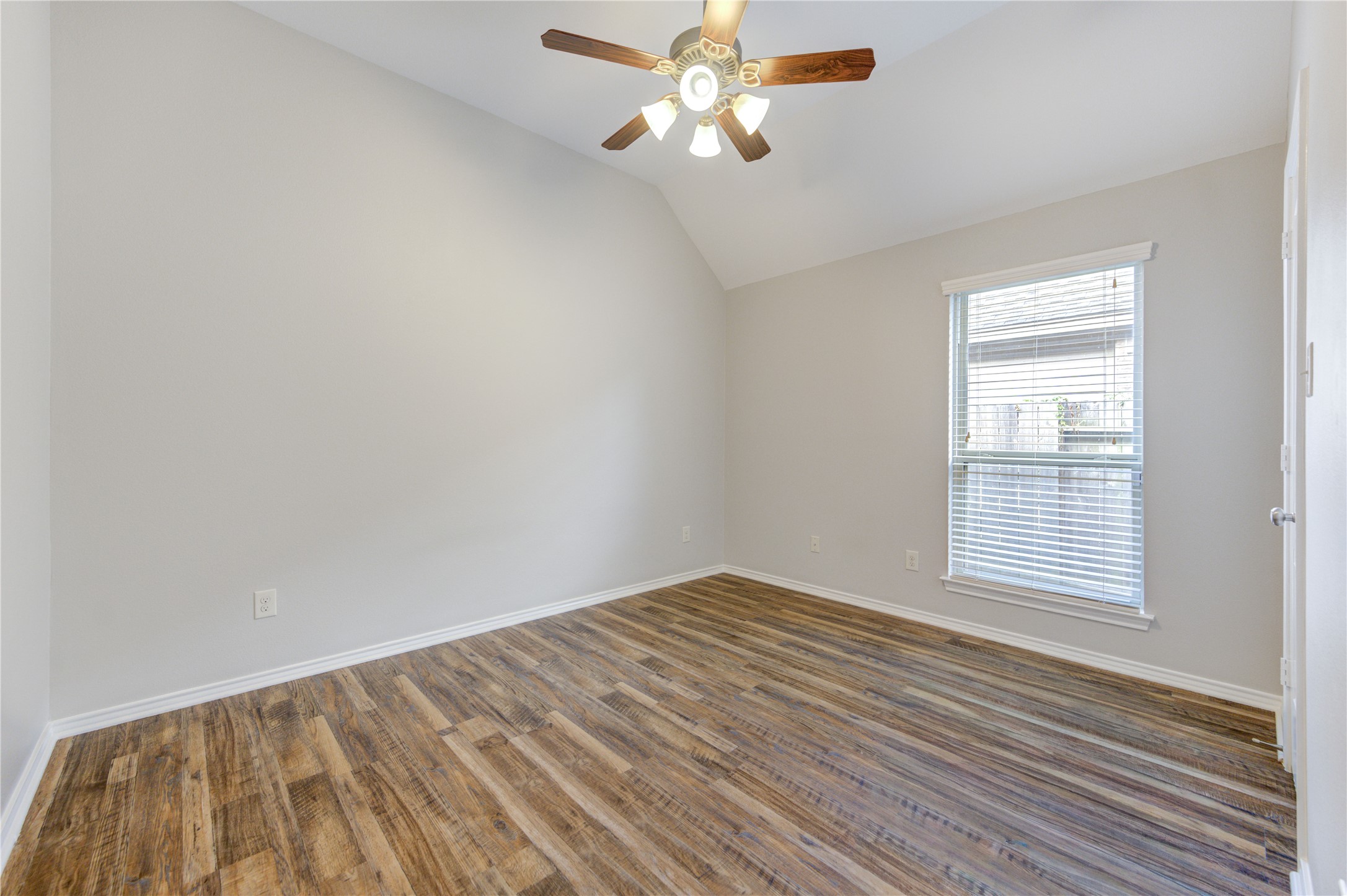 27407 Gatlin Lane Spring, TX 77386 - Photo 27 of 35 A spacious secondary bedroom with soaring ceilings, durable wood-look flooring, and abundant natural light creates a comfortable retreat for family, guests, or a home office.