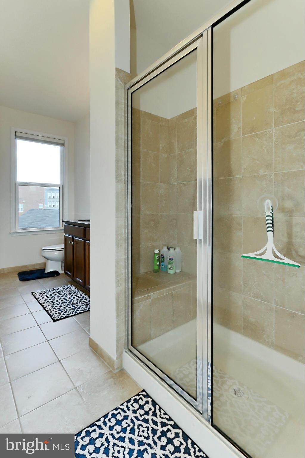 9419 Zebedee Street Manassas, VA 20110 - Photo 19 of 30 a bathroom with a bathtub and a shower