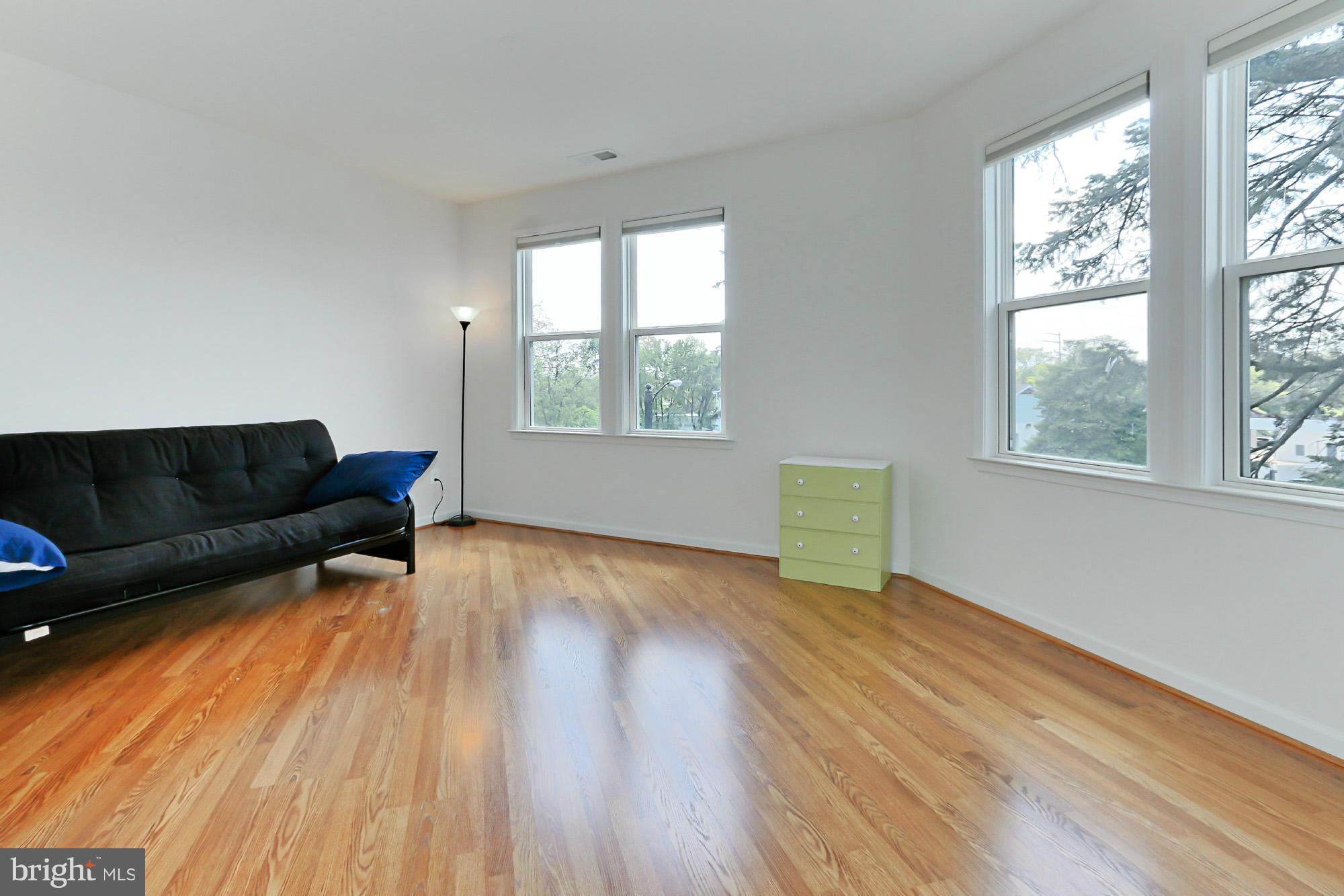 9419 Zebedee Street Manassas, VA 20110 - Photo 21 of 30 a living room with a couch wooden floor and a window