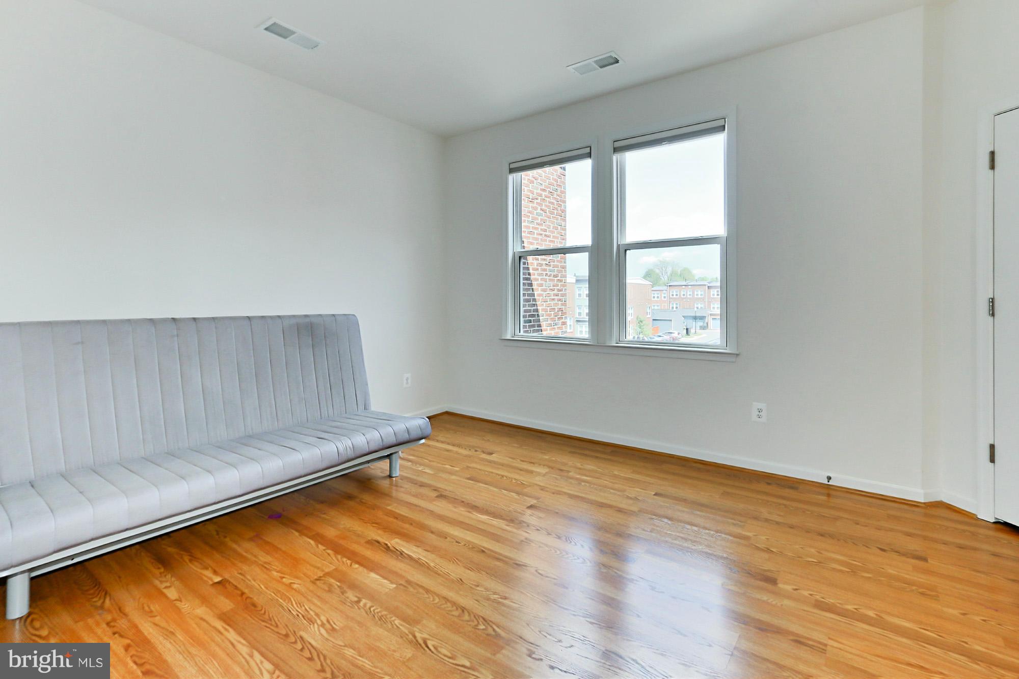 9419 Zebedee Street Manassas, VA 20110 - Photo 23 of 30 an empty room with wooden floor and windows