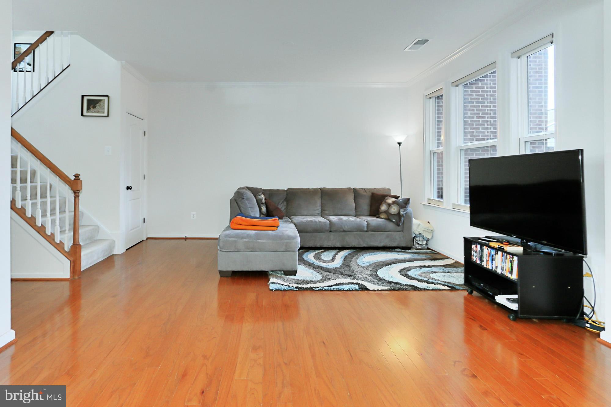 9419 Zebedee Street Manassas, VA 20110 - Photo 7 of 30 a living room with furniture and a flat screen tv