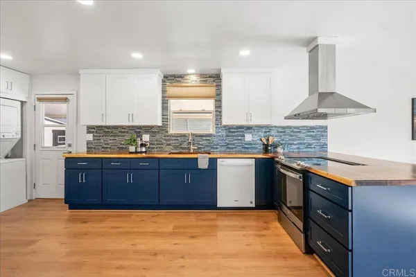 a kitchen with granite countertop a sink stove and cabinets