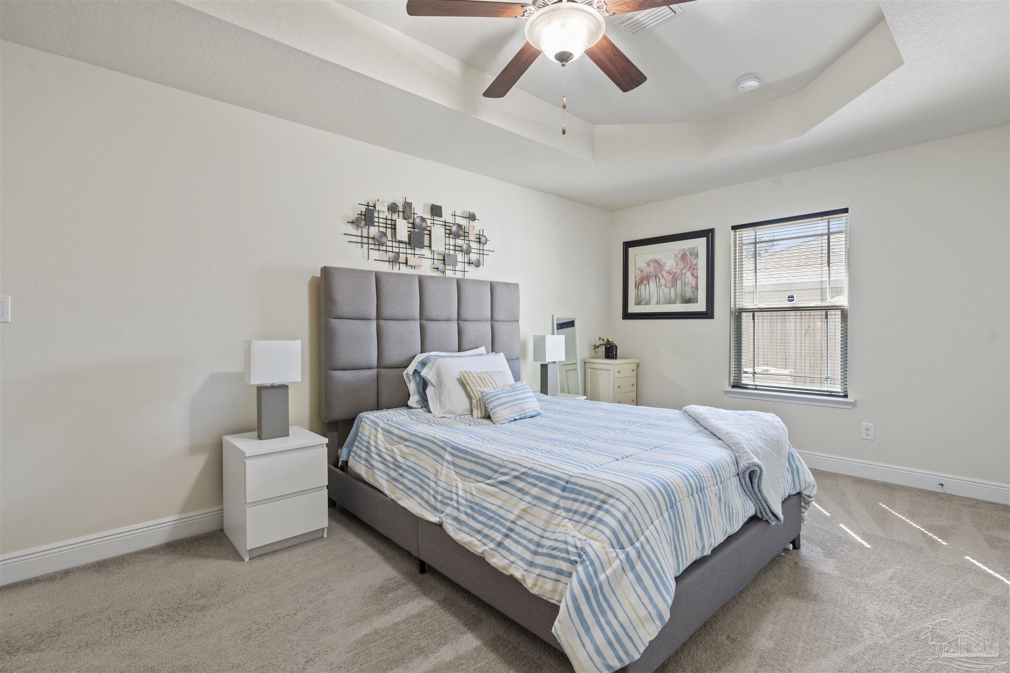 151 Cottage View Drive Pensacola, FL 32507 - Photo 11 of 17 a bedroom with a large bed and a chandelier