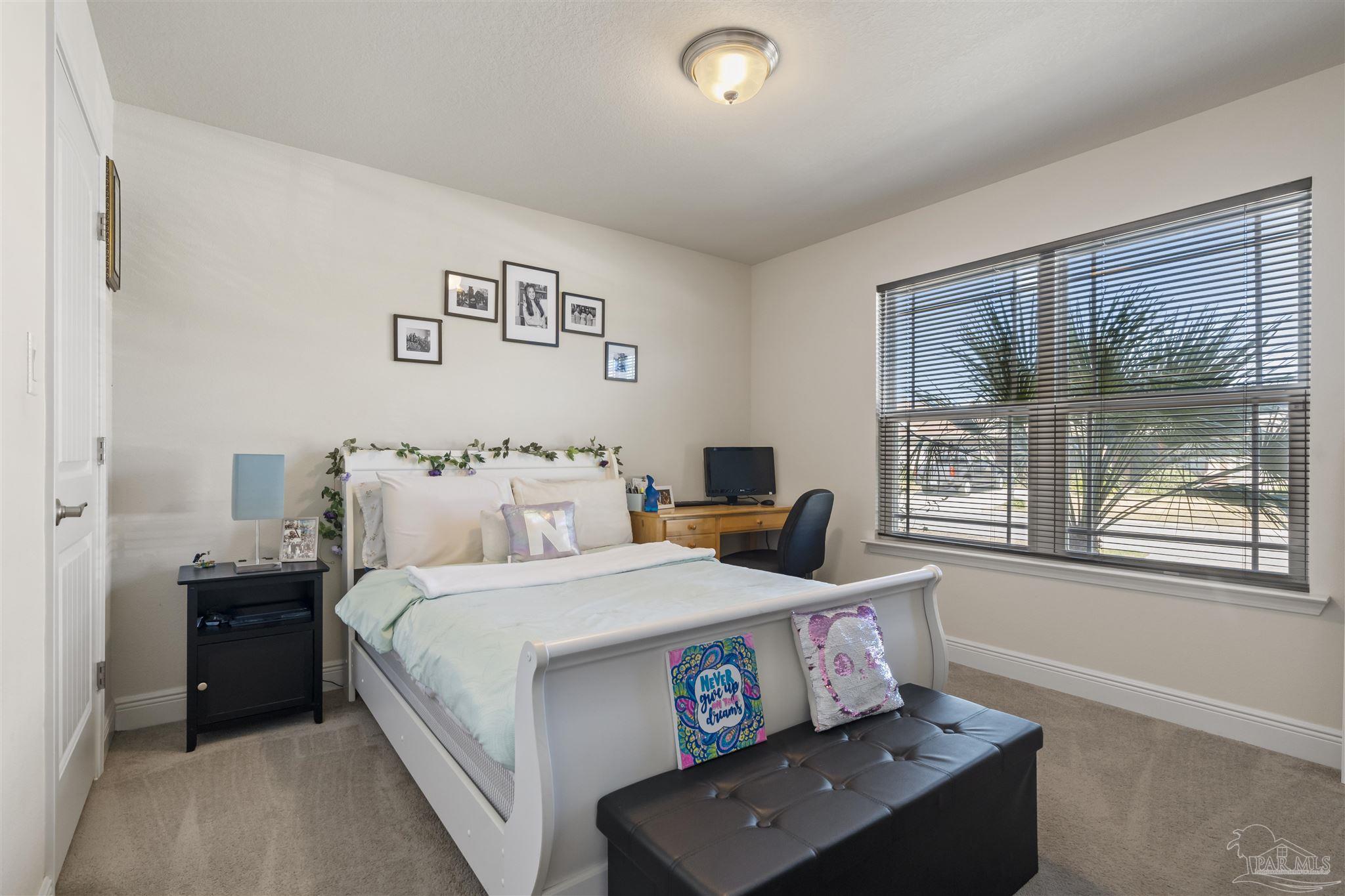 151 Cottage View Drive Pensacola, FL 32507 - Photo 13 of 17 a bedroom with a bed and large windows