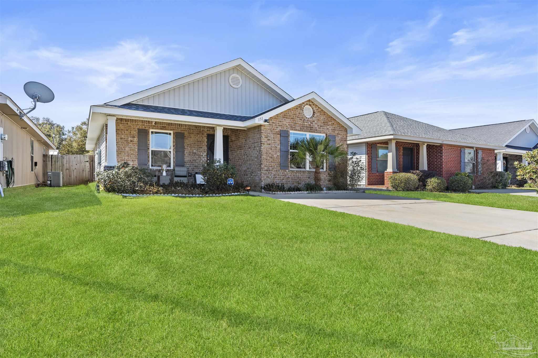 151 Cottage View Drive Pensacola, FL 32507 - Photo 2 of 17 a front view of a house with a yard and trees