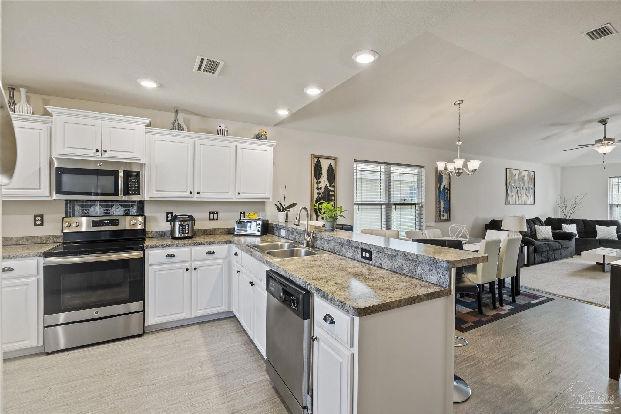 151 Cottage View Drive Pensacola, FL 32507 - Photo 3 of 17 a kitchen with a sink stove and cabinets