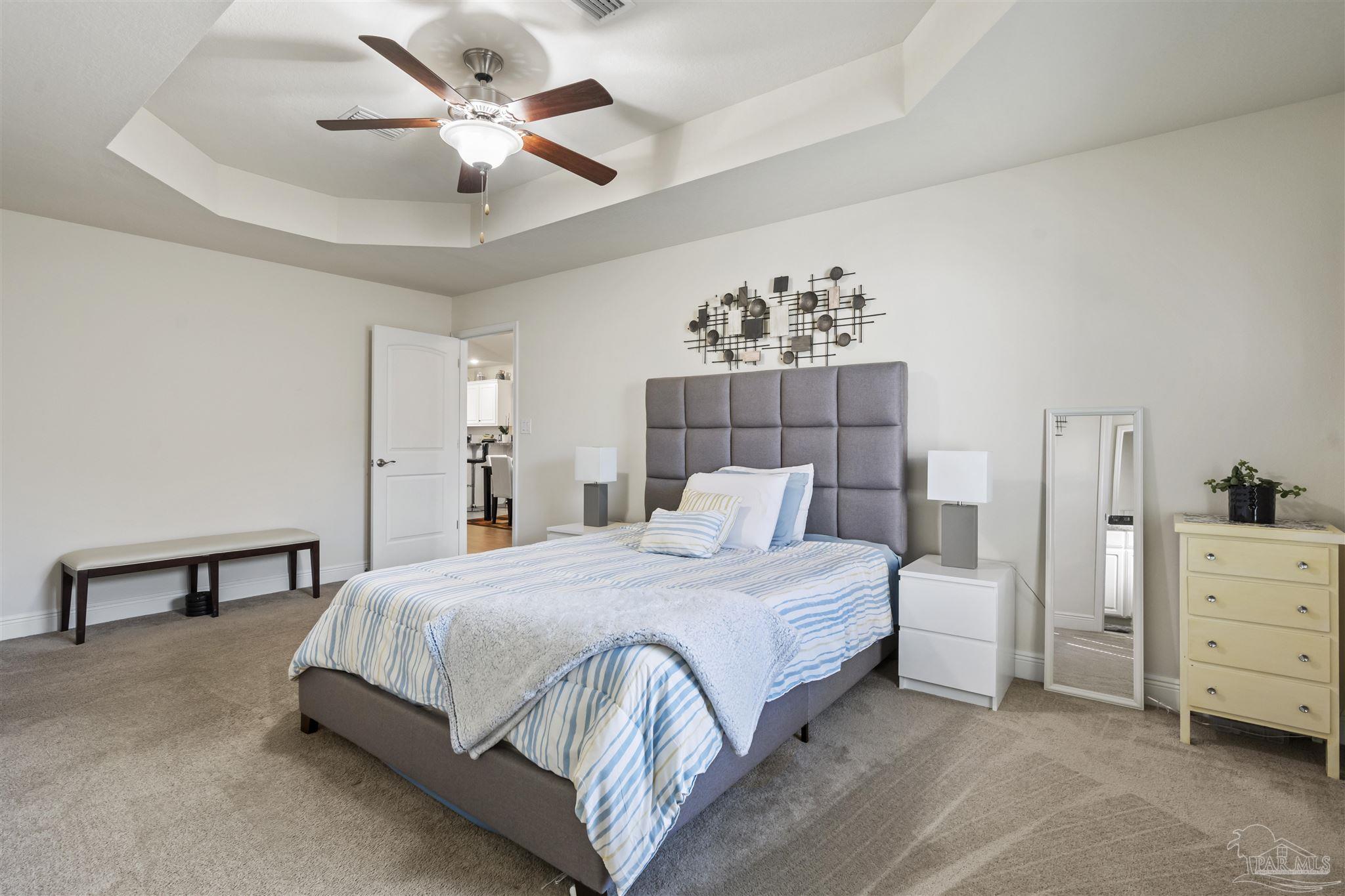 151 Cottage View Drive Pensacola, FL 32507 - Photo 10 of 17 a bedroom with a bed and a chandelier