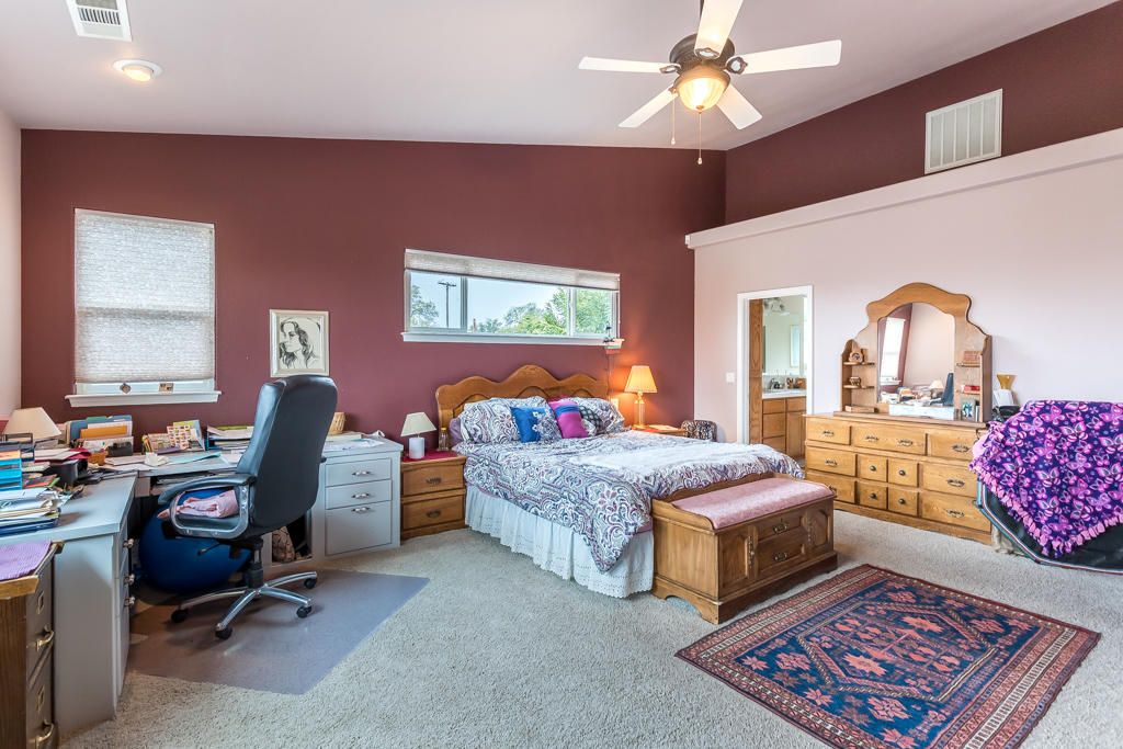 1575 Barbara Road Redding, CA 96003 - Photo 11 of 27 a bedroom with furniture and a chandelier