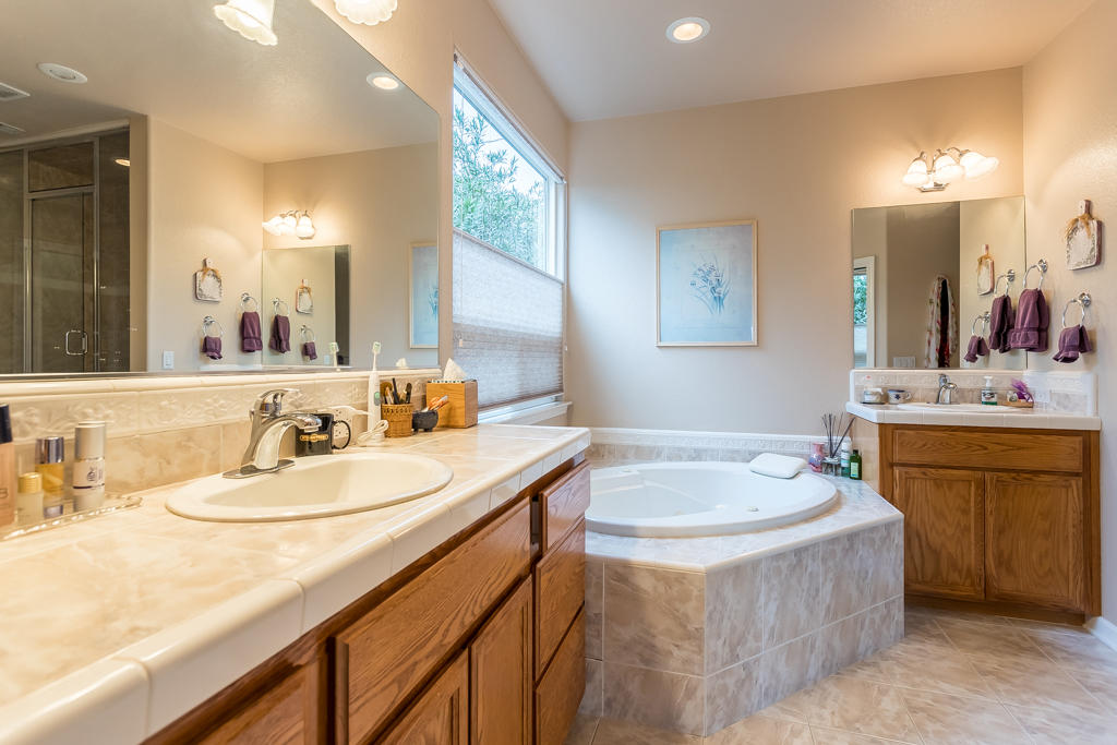 1575 Barbara Road Redding, CA 96003 - Photo 12 of 27 a bathroom with a granite countertop sink and a mirror