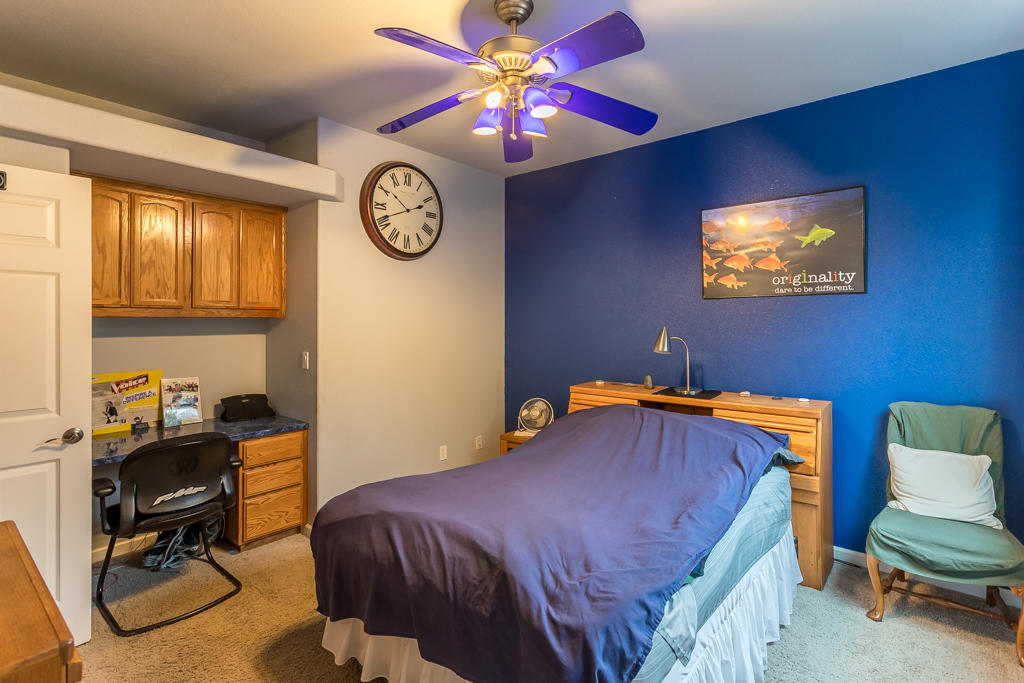 1575 Barbara Road Redding, CA 96003 - Photo 19 of 27 a bedroom with a bed and a chair with the walls