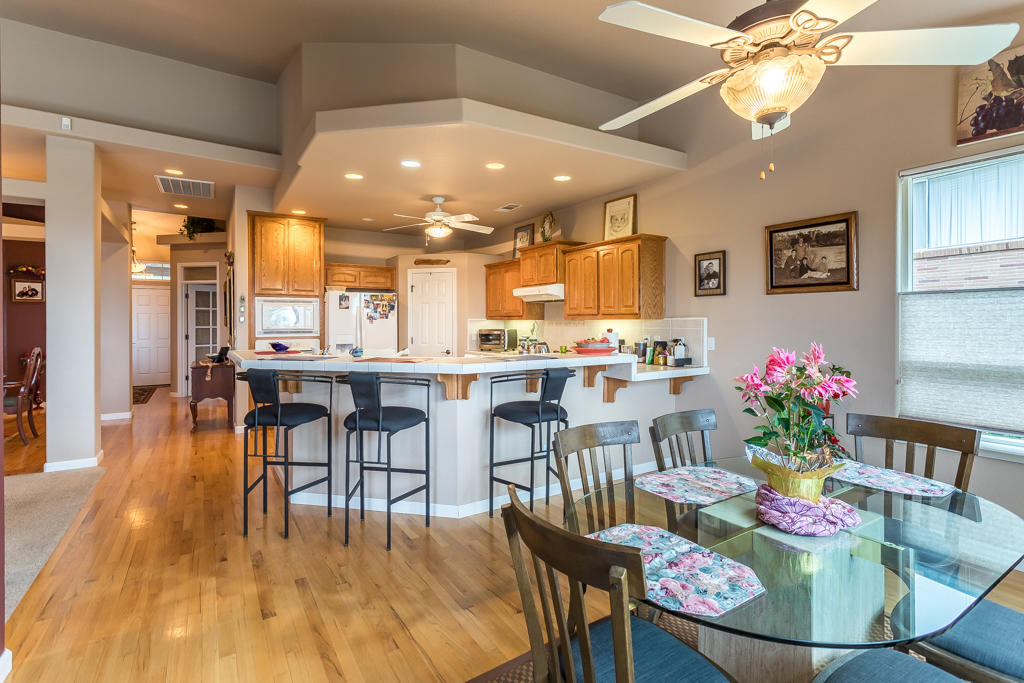 1575 Barbara Road Redding, CA 96003 - Photo 8 of 27 a dining room with stainless steel appliances kitchen island granite countertop a dining table chairs and a living room view