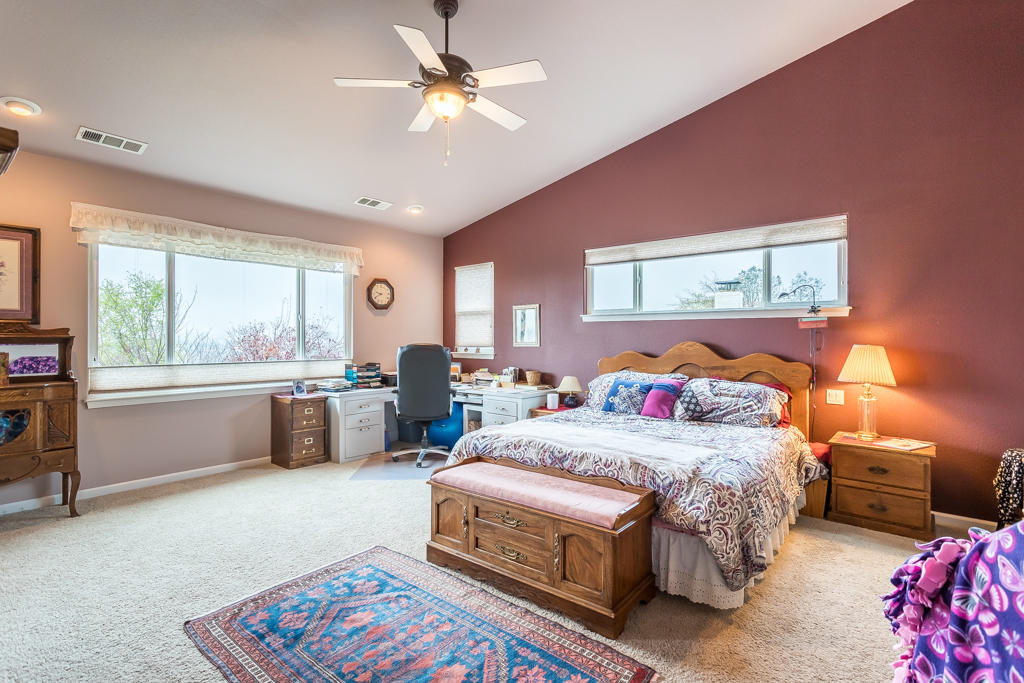 1575 Barbara Road Redding, CA 96003 - Photo 10 of 27 a bedroom with a bed and a chandelier