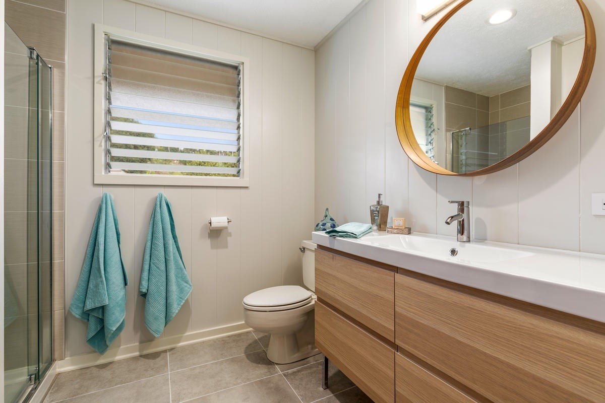 82-1019 KOA Road Captain Cook, HI 96704 - Photo 14 of 23 a bathroom with a toilet sink and mirror