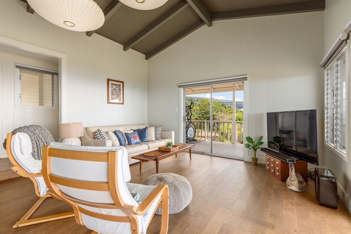 82-1019 KOA Road Captain Cook, HI 96704 - Photo 6 of 23 a living room with furniture a flat screen tv and a large window