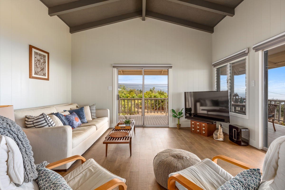 82-1019 KOA Road Captain Cook, HI 96704 - Photo 7 of 23 a living room with furniture and a flat screen tv