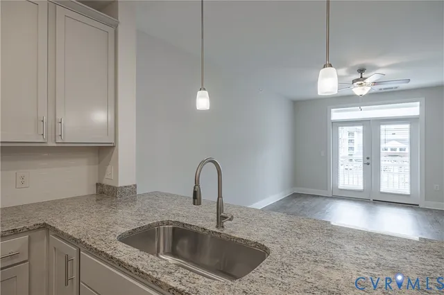 a kitchen with a sink and chandelier