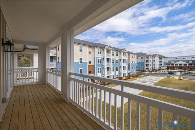 a view of a balcony with wooden floor and city view