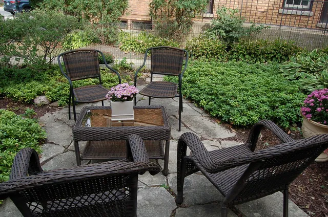 a table and chairs sitting in front of a building
