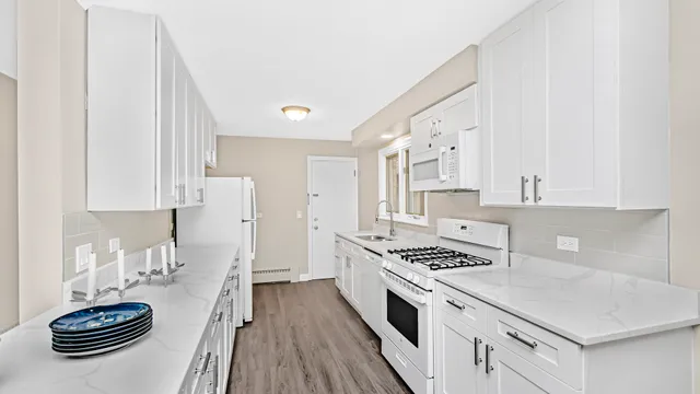 a kitchen with sink refrigerator stove and cabinets