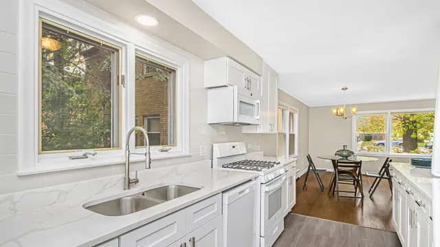 a kitchen with a sink a counter top space and stainless steel appliances