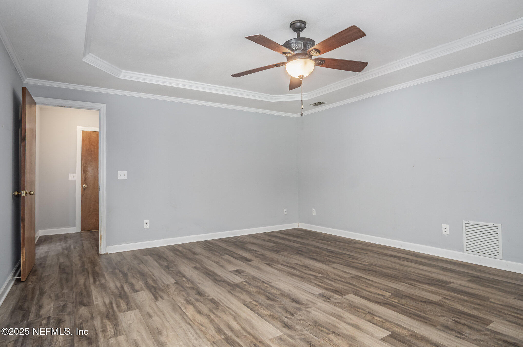 12046 Acornshell Way Jacksonville, FL 32223 - Photo 14 of 28 an empty room with wooden floor and a ceiling fan
