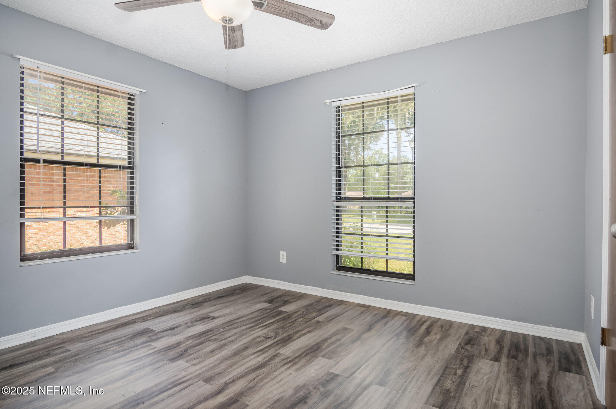 12046 Acornshell Way Jacksonville, FL 32223 - Photo 20 of 28 an empty room with wooden floor and windows