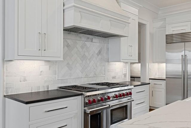a kitchen with granite countertop cabinets and steel stainless steel appliances