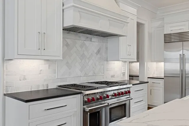 a kitchen with granite countertop cabinets and steel stainless steel appliances