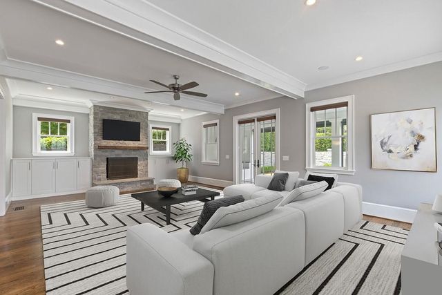 a living room with furniture a fireplace and a flat screen tv