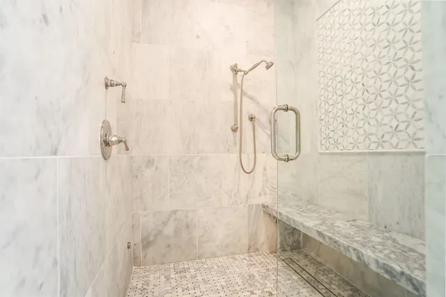 a bathroom with a granite countertop shower