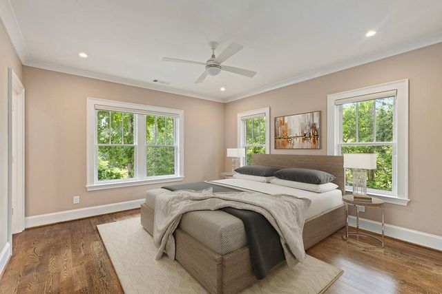 a bedroom with a bed and a large window