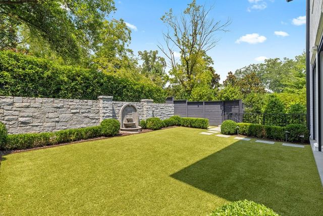a view of a back yard of the house with a yard